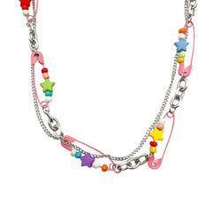 Harajuku Style Layered Chain A trendy Harajuku-inspired necklace combining silver chains, colorful star beads, and pink enamel safety pins for a bold, street-style look.