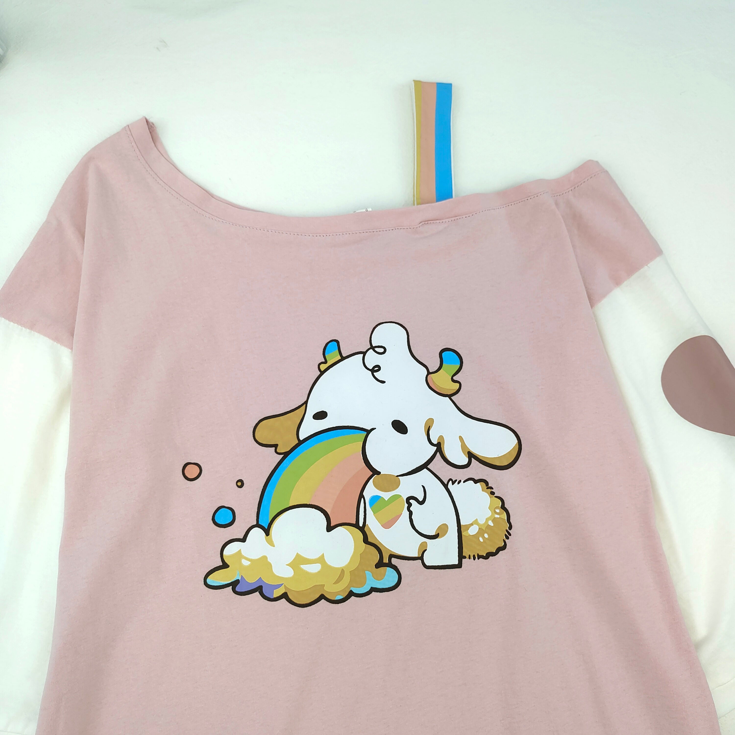 Close-up of cartoon rainbow deer print on pink shirt rainbow graphic tee dress