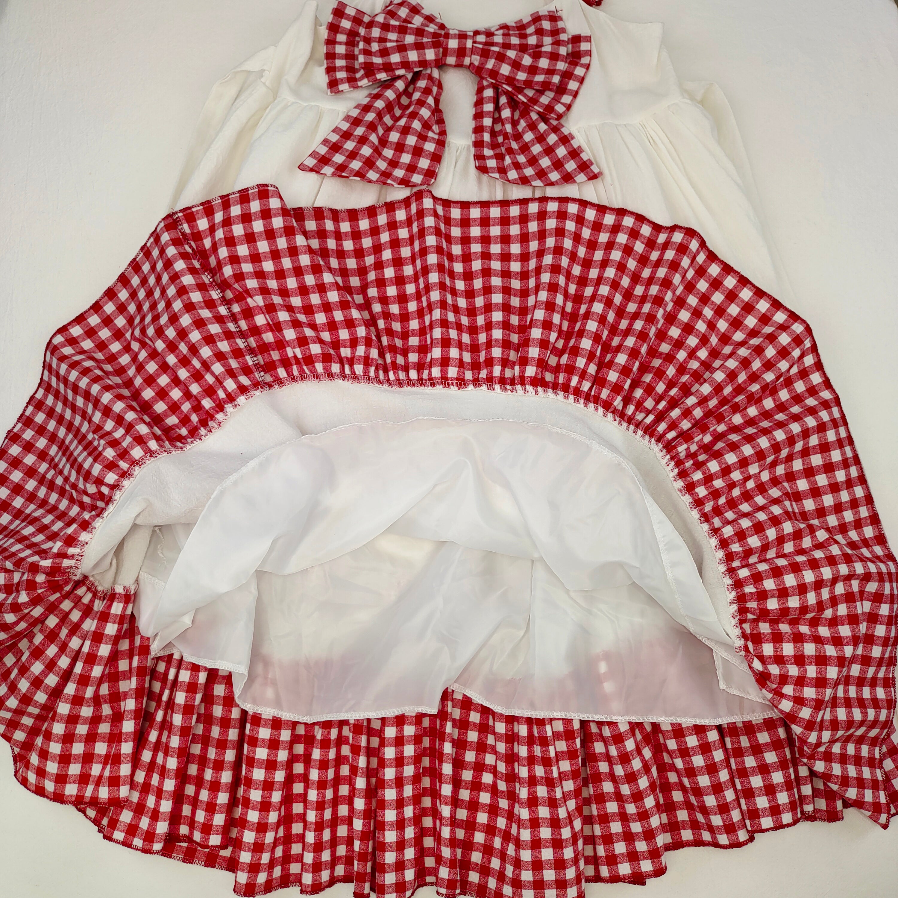 Sweet country-style dress with layered ruffles and red checkered trim.