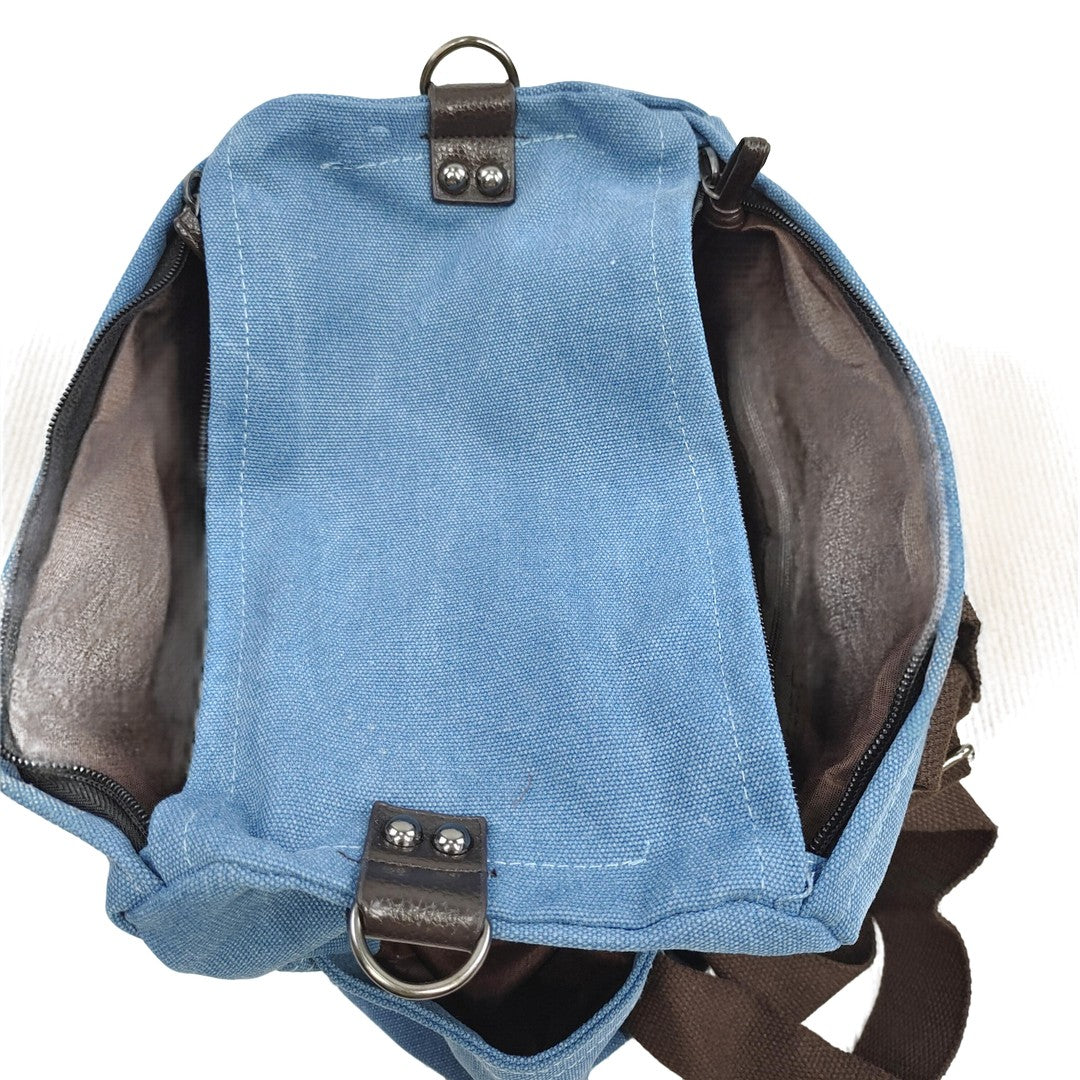 Interior view of blue canvas backpack with brown lining and zipper pocket