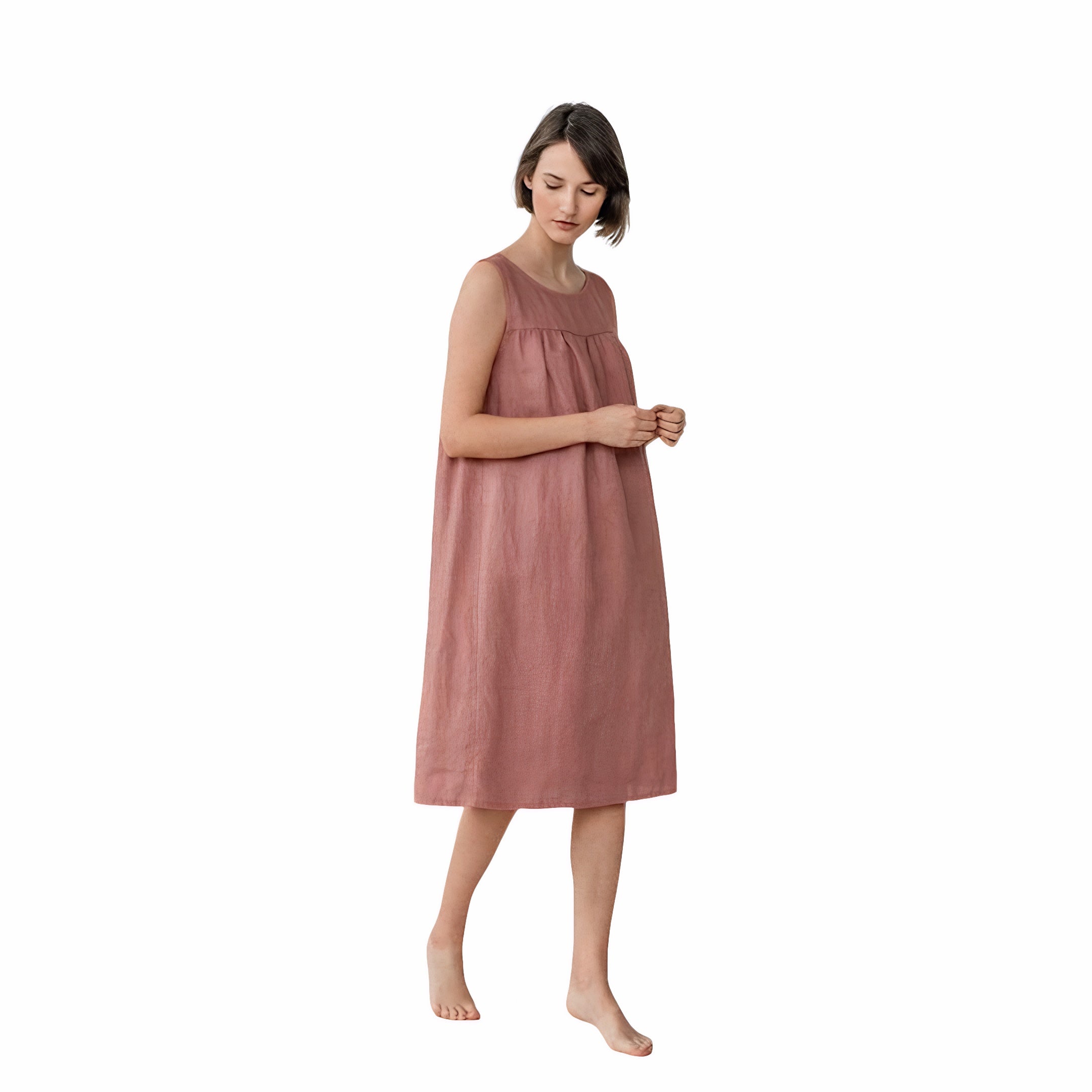 Woman wearing sleeveless linen babydoll dress in pink