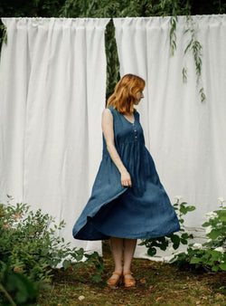 Woman in dark denim blue linen midi dress walking outdoors