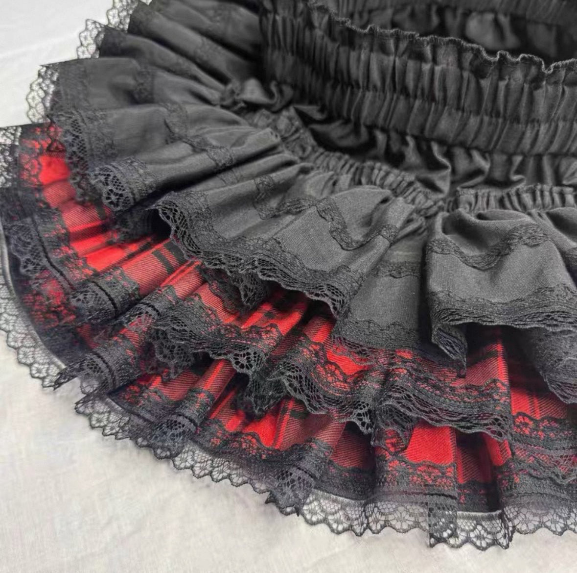 Inner short lining of red tartan layered mini skirt