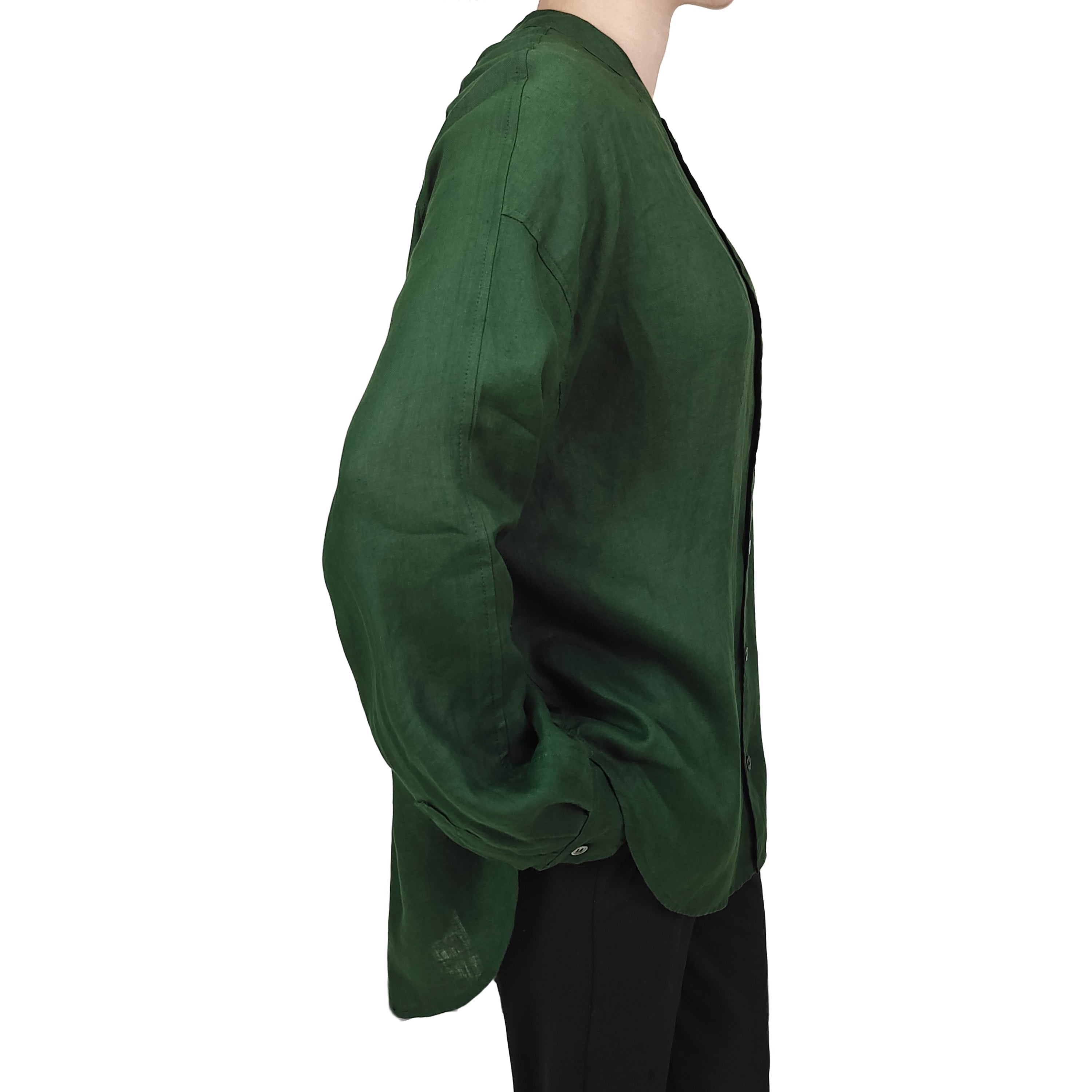 Side view of loose white han hemp shirt paired with brown pants in sunlight