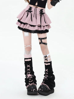 Model wearing black gothic ruffle mini skirt with red bow accents
