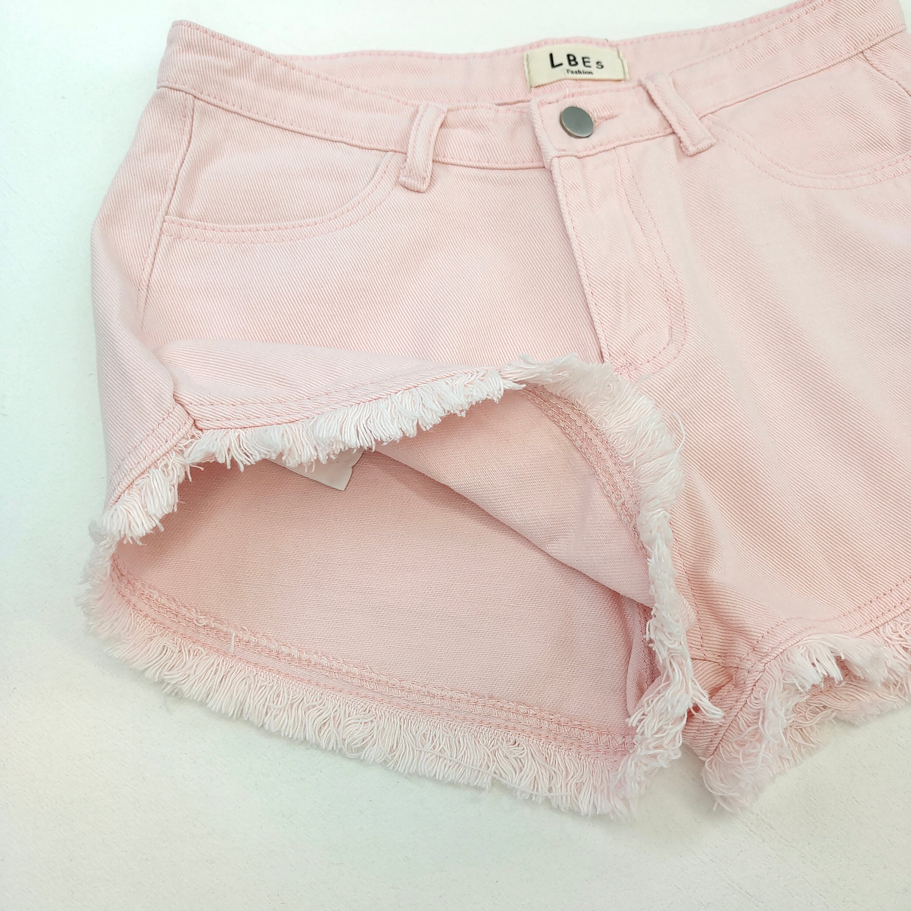 Light pink denim shorts with frayed hem