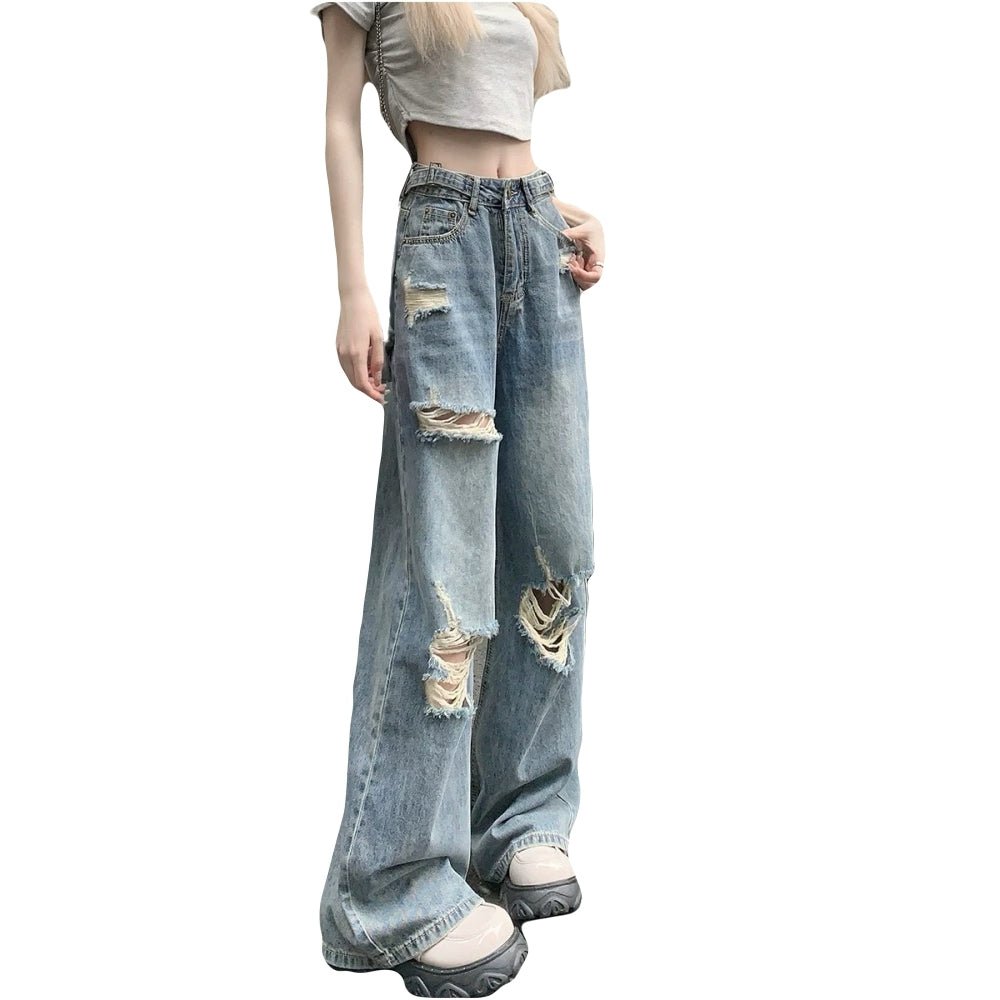 Model wearing plus size vintage ripped denim jeans with high waist and wide legs