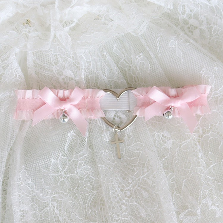 Pink sweet-style garter belt with bows, bell, and adjustable strap.