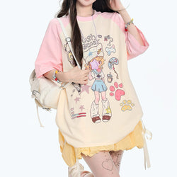 Girl wearing pastel pink and cream Push Beeb loose-fit graphic tee with cartoon design