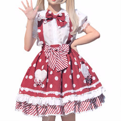 A young woman wearing a red polka dot Lolita skirt with white frills and striped bows