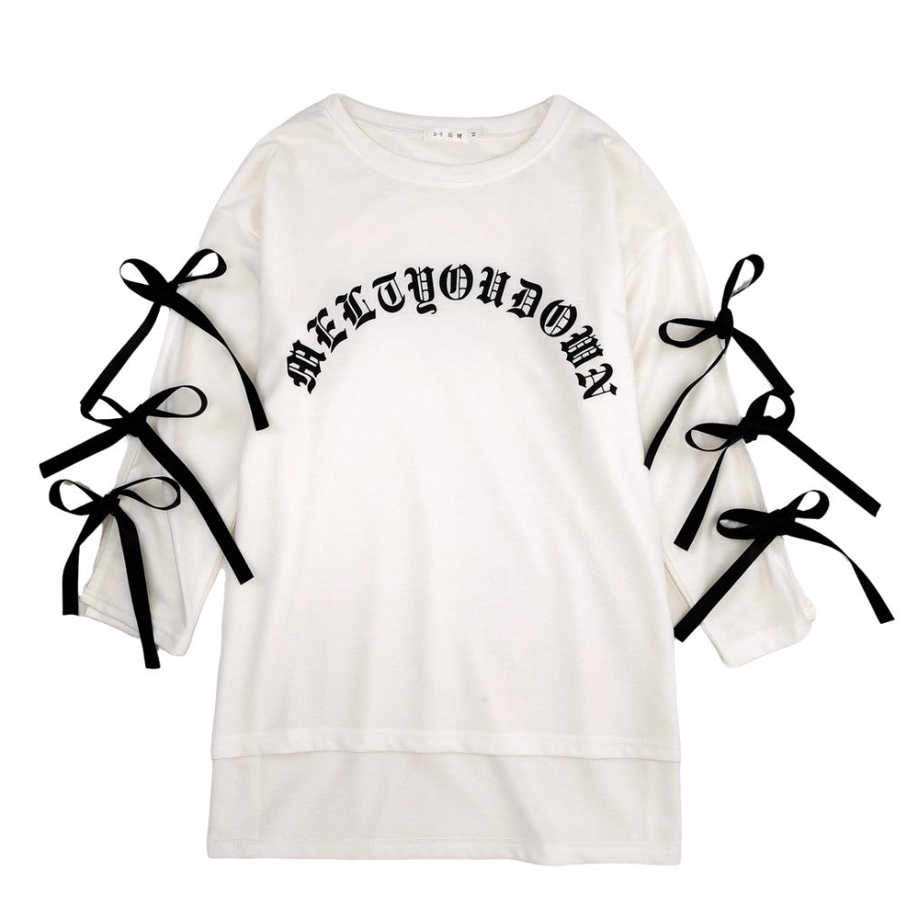 White kawaii top with black ribbon bows on sleeves and gothic MELTYOURDOWN print