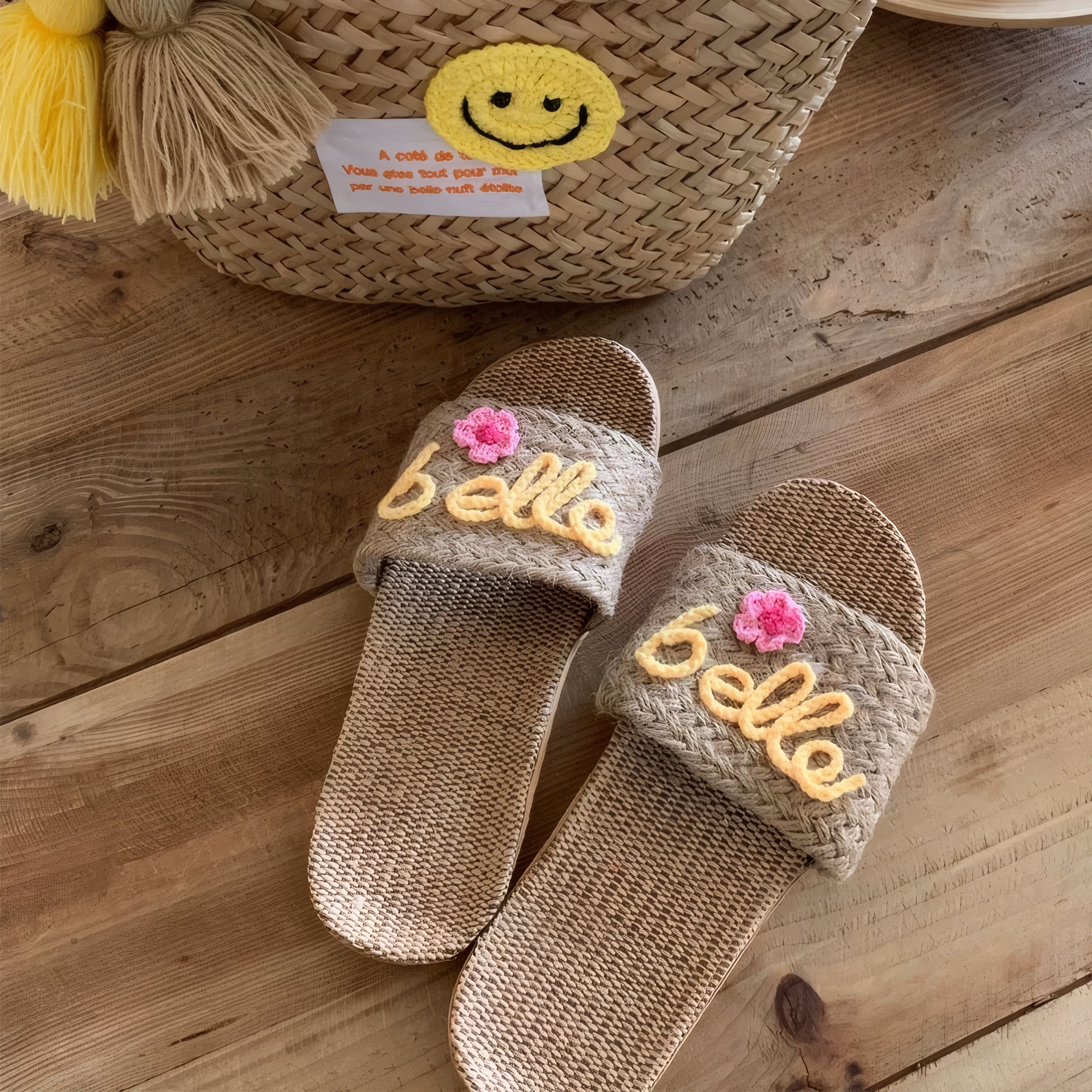 Handmade personalized straw tote bags with names "Any" and "Laurel" in blue yarn embroidery