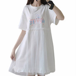 Girl wearing a white T-shirt dress with bunny print and sheer pleated mesh skirt in kawaii style