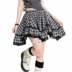 Model wearing black plaid high-waisted mini skirt with lace hem
